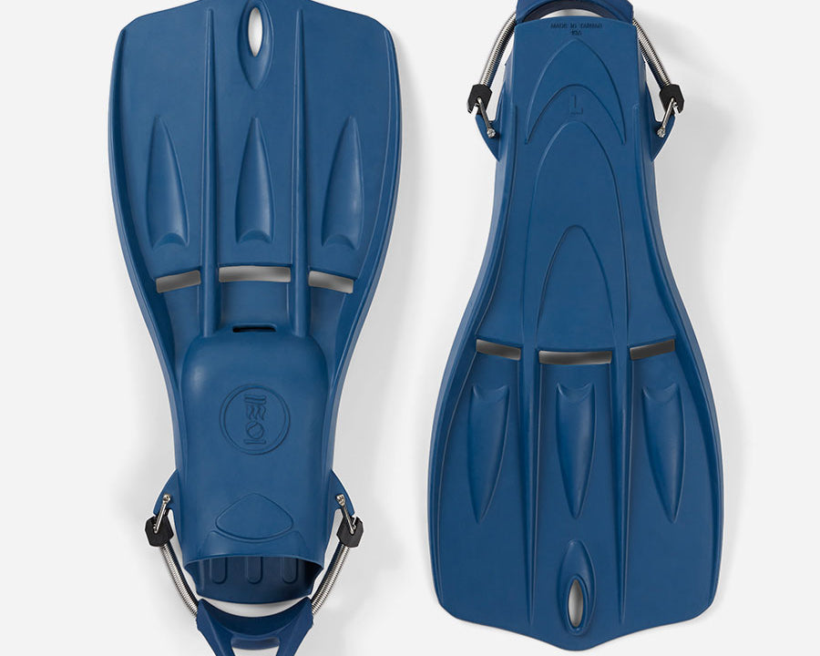 A pair of blue Tech Fins designed for scuba diving, featuring a vented blade and spring straps.